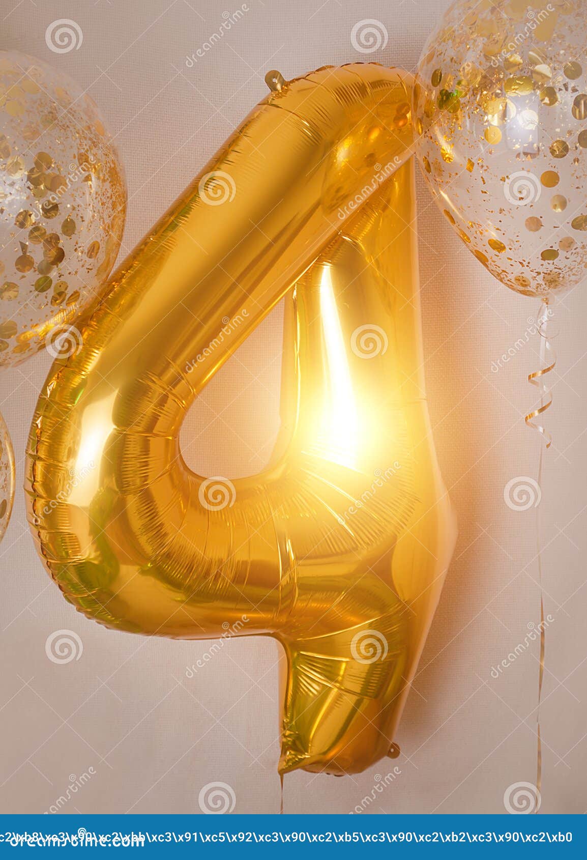 room decorated for a birthday party with golden, green and yellow baloons, large inflatable number 4, dinosaur baloons