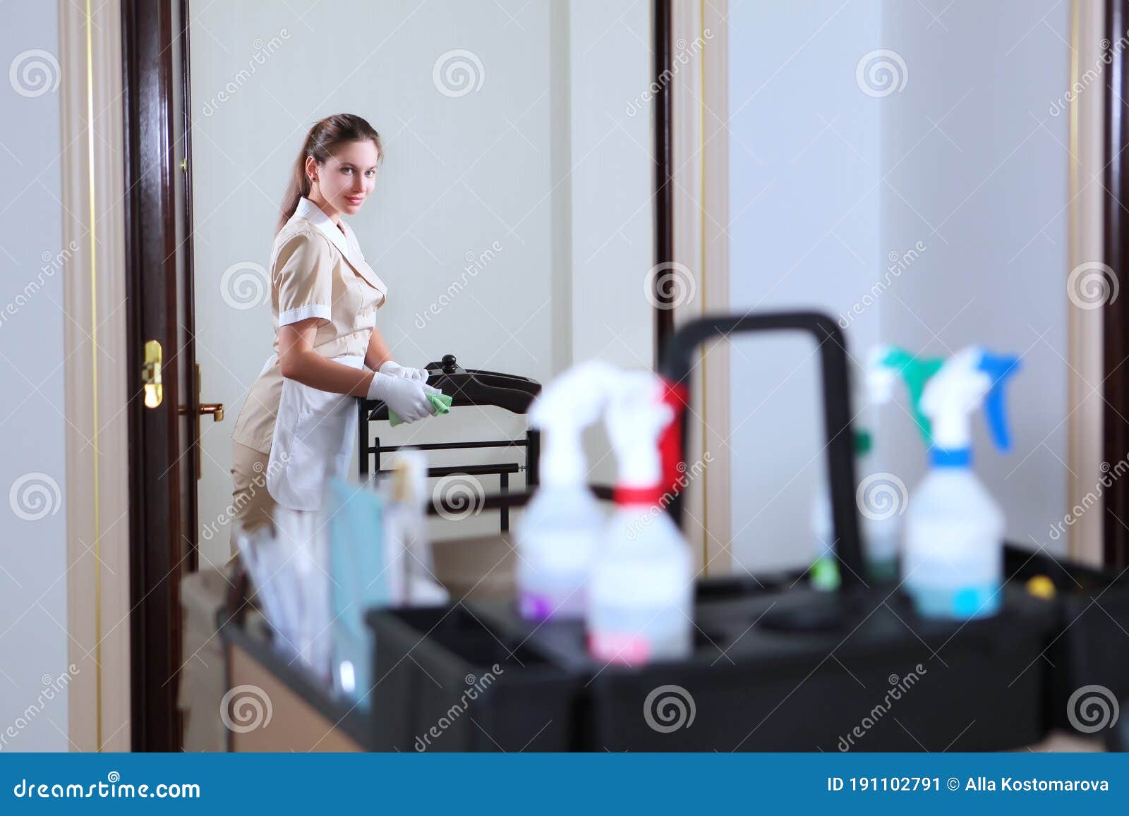 Room Servicea Uniformed Maid Cleans The Roommaid`s Cart With Work 