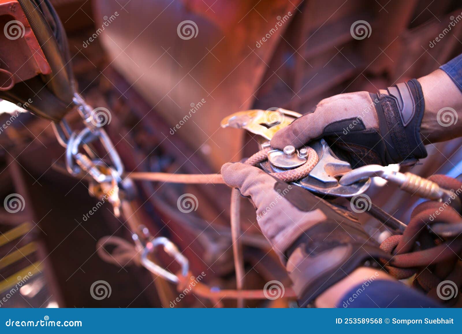 rope access technician hand wearing a safety glove performing inserting 10.5 mm low stretch strength rope