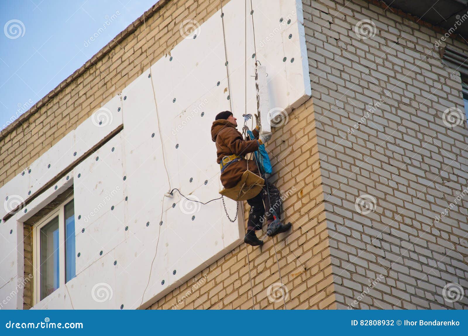 Rope Access Worker Makes Insulation with Styrofoam Editorial