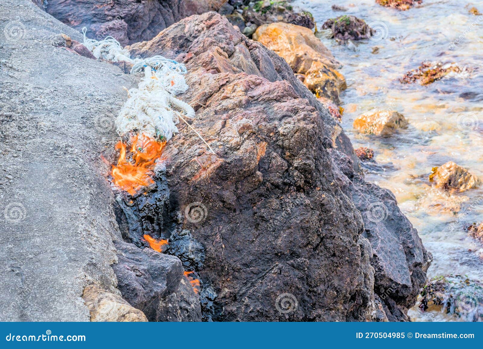 Rope Burning on Top of Large Boulder Stock Image Image of ocean, cord