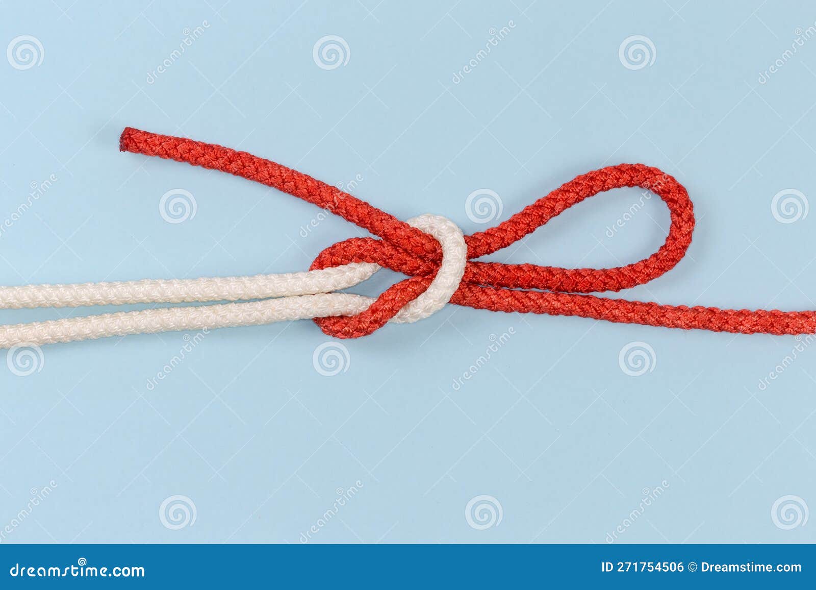 Rope Singly Slipped Reef Knot on a Blue Background Stock Photo Image