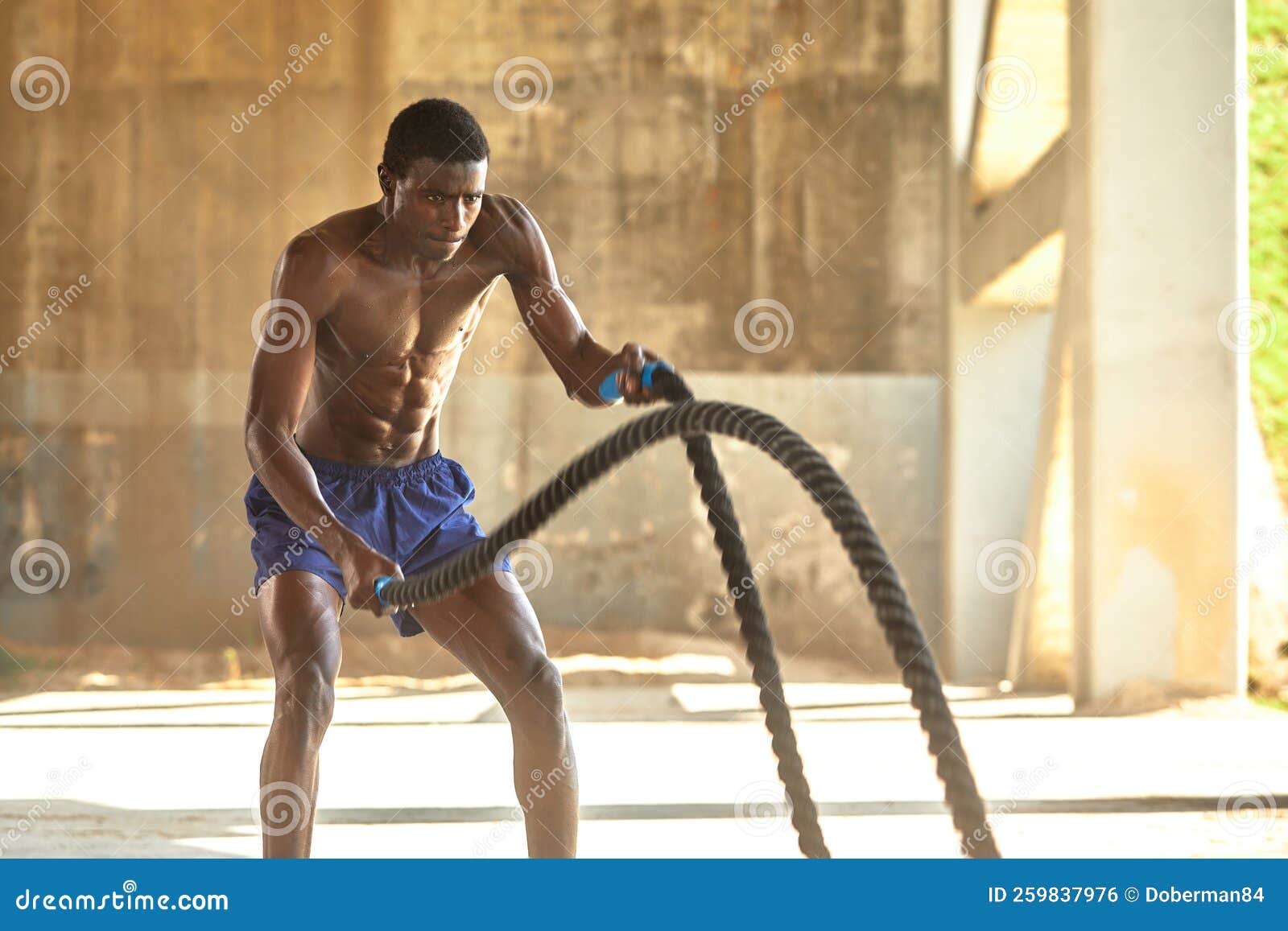 Rope Workout. Sport Man Doing Battle Ropes Exercise Outdoor Stock