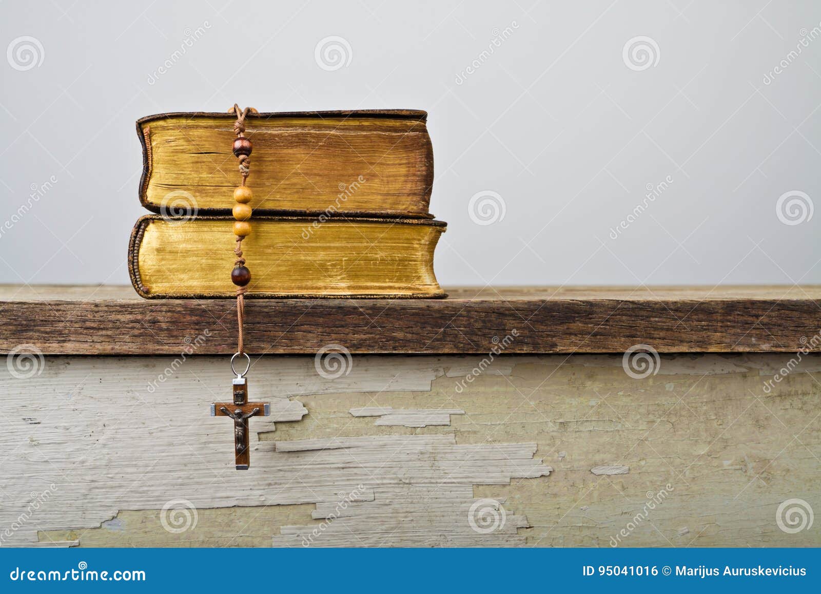 rosary beads and books of catholic church liturgy