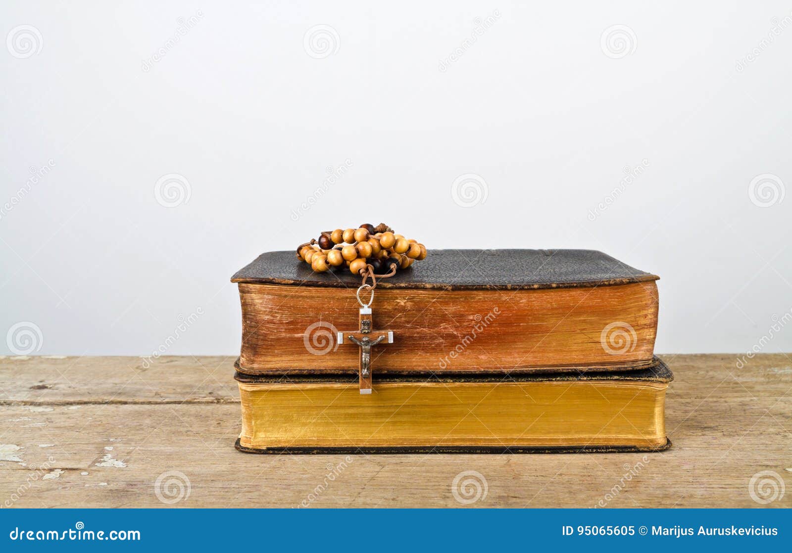 rosary beads and books of catholic church liturgy