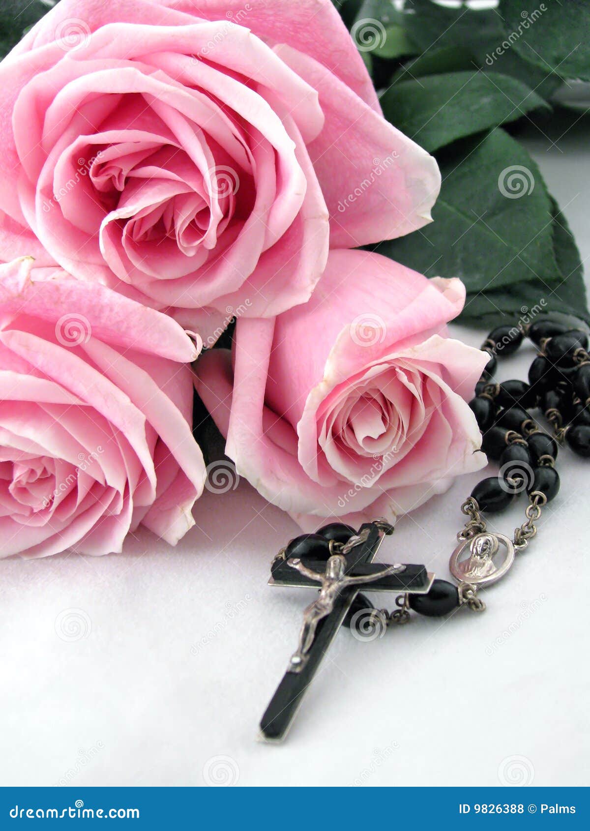rosary cross and pink roses
