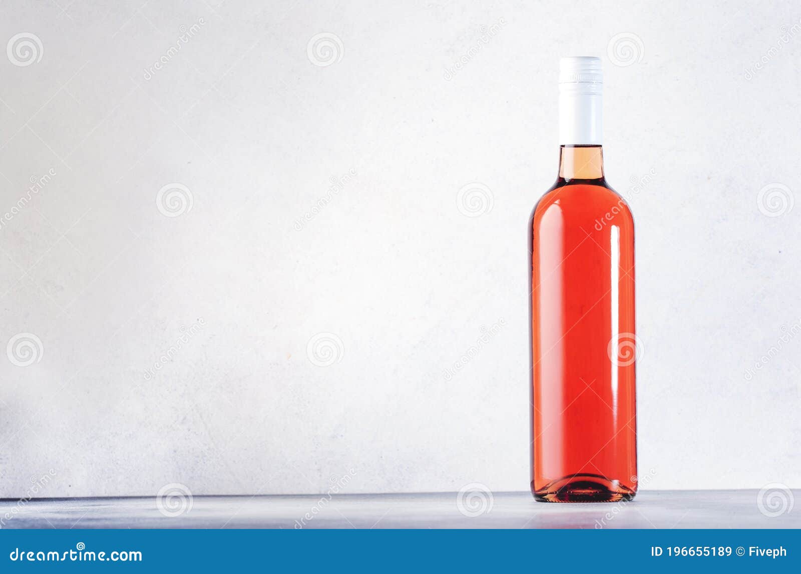 rose wine bottle on the gray table. pink rosado, rosato or blush wine tasting in wineshop, bar concept. copy space