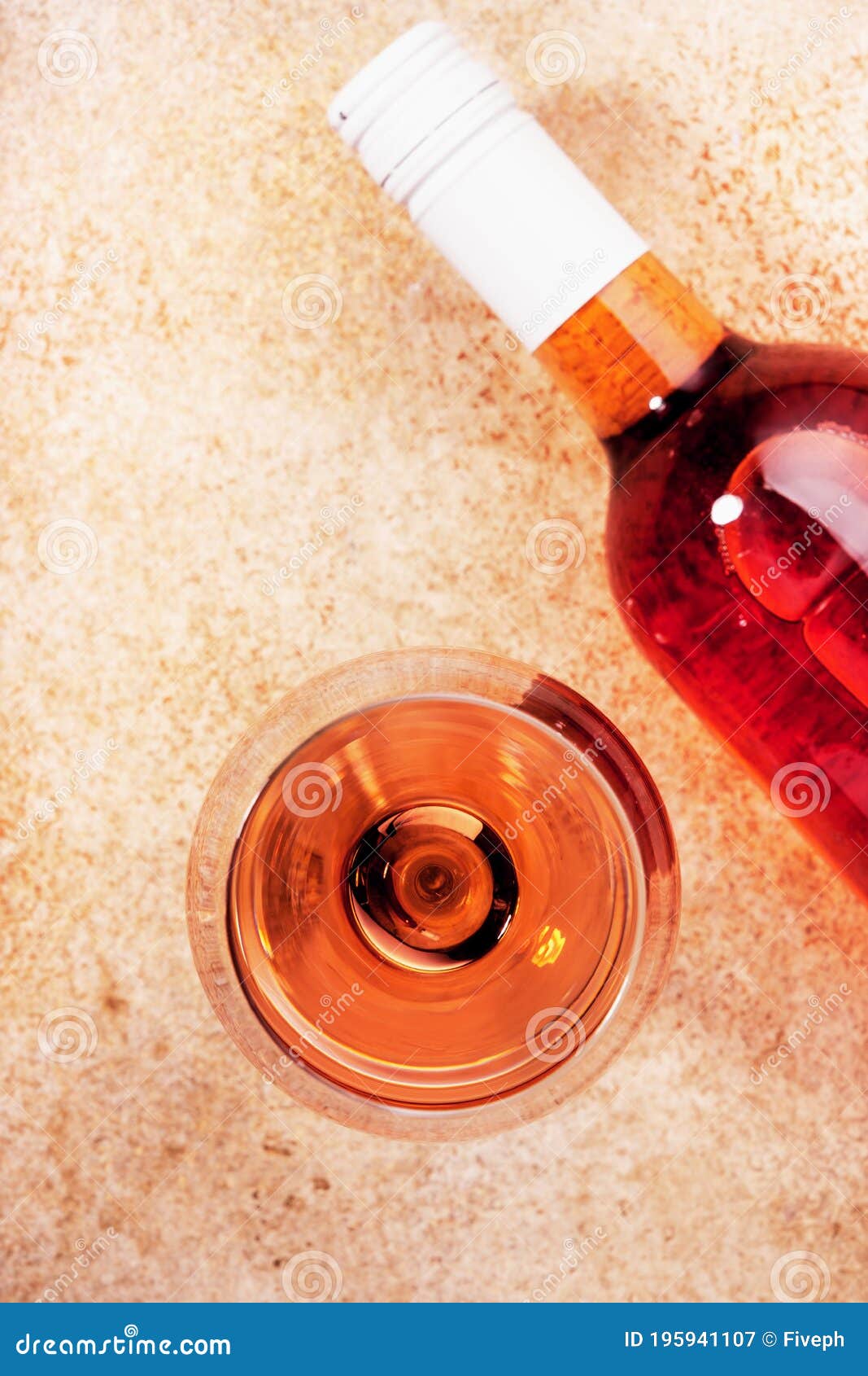 rose wine glass with bottle on the beige table. rosado, rosato or blush wine tasting in wineshop, bar concept. copy space, top