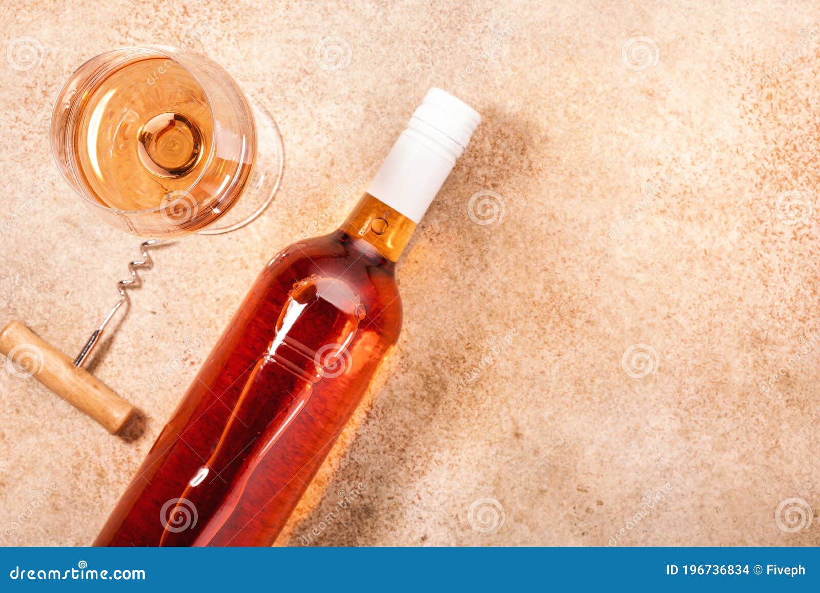 rose wine glass with bottle on the beige table. rosado, rosato or blush wine tasting in wineshop, bar concept. copy space, top