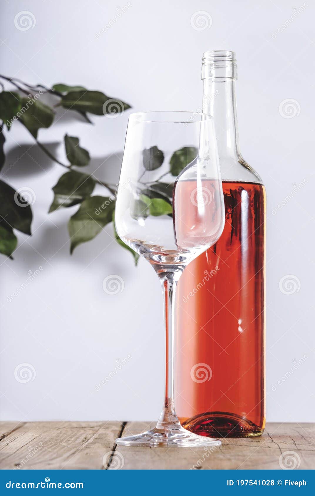 rose wine glass with bottle on the white table. rosado, rosato or blush wine tasting in wineshop, bar concept. copy space