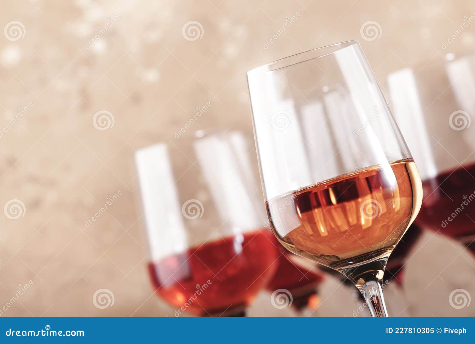 rose wine glasses on the beige table. rosado, rosato or blush wine tasting concept, negative space