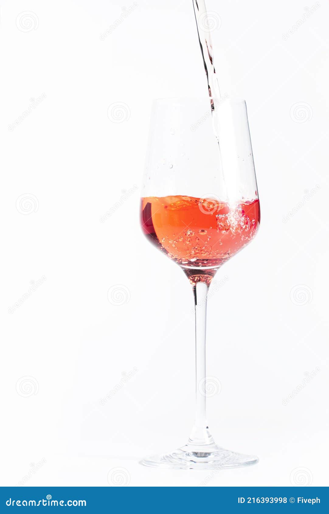 rose wine pouring out of the bottle, white bakcground. rosado, rosato or blush wine tasting in wineshop, bar concept. copy space
