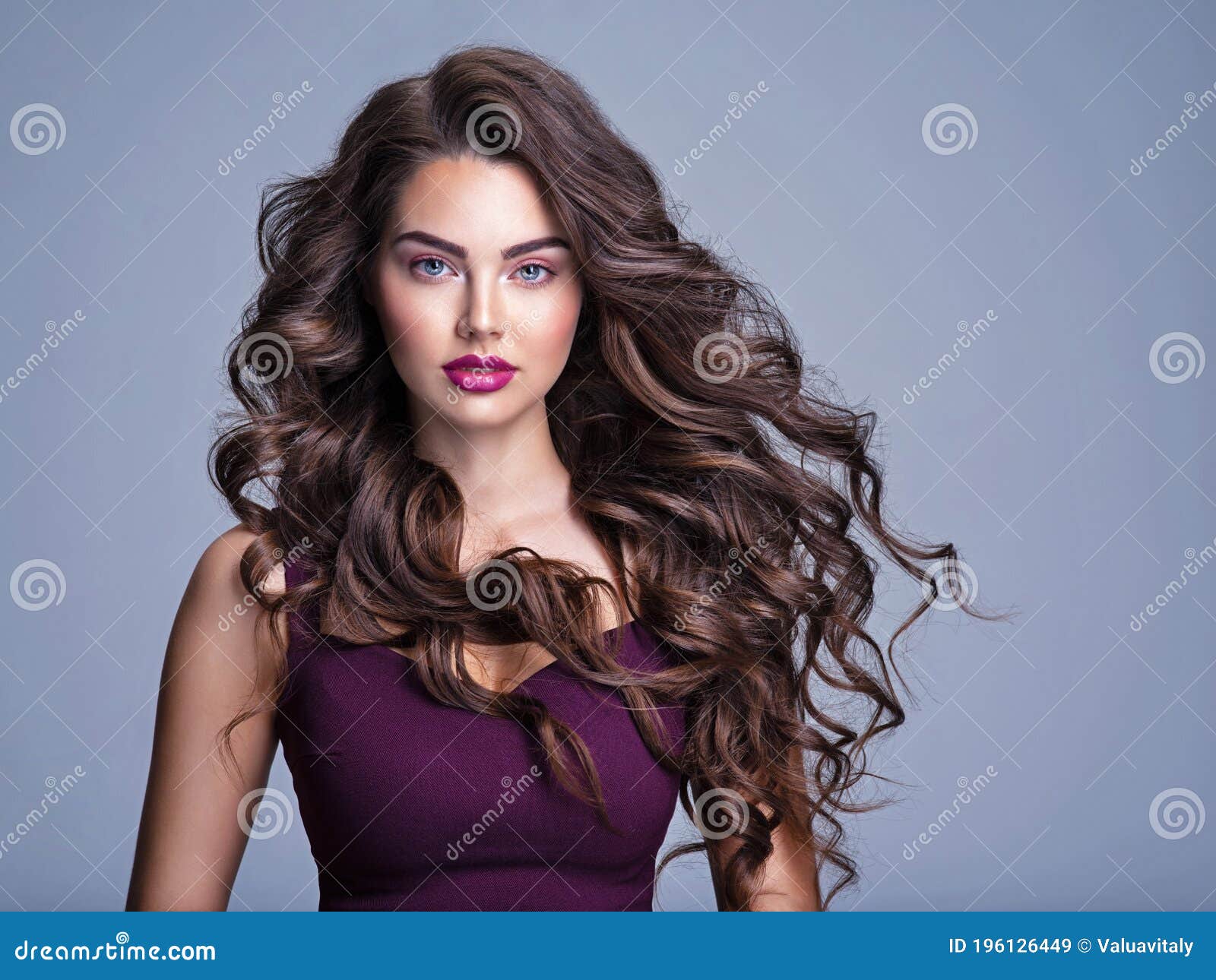 Mulher jovem e bonita de cabelos castanhos com cabelo volumoso e