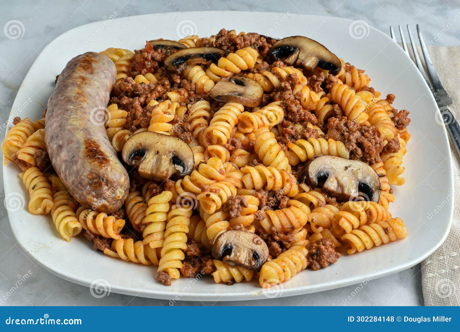 Rotini Pasta with a Meat Sauce and Italian Sausage Stock Photo - Image