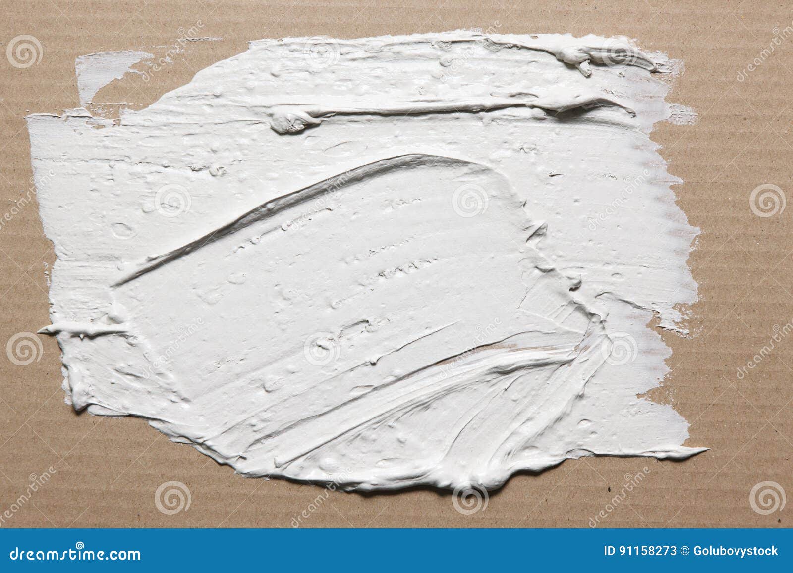 rough texture of smeared white stucco on cardboard