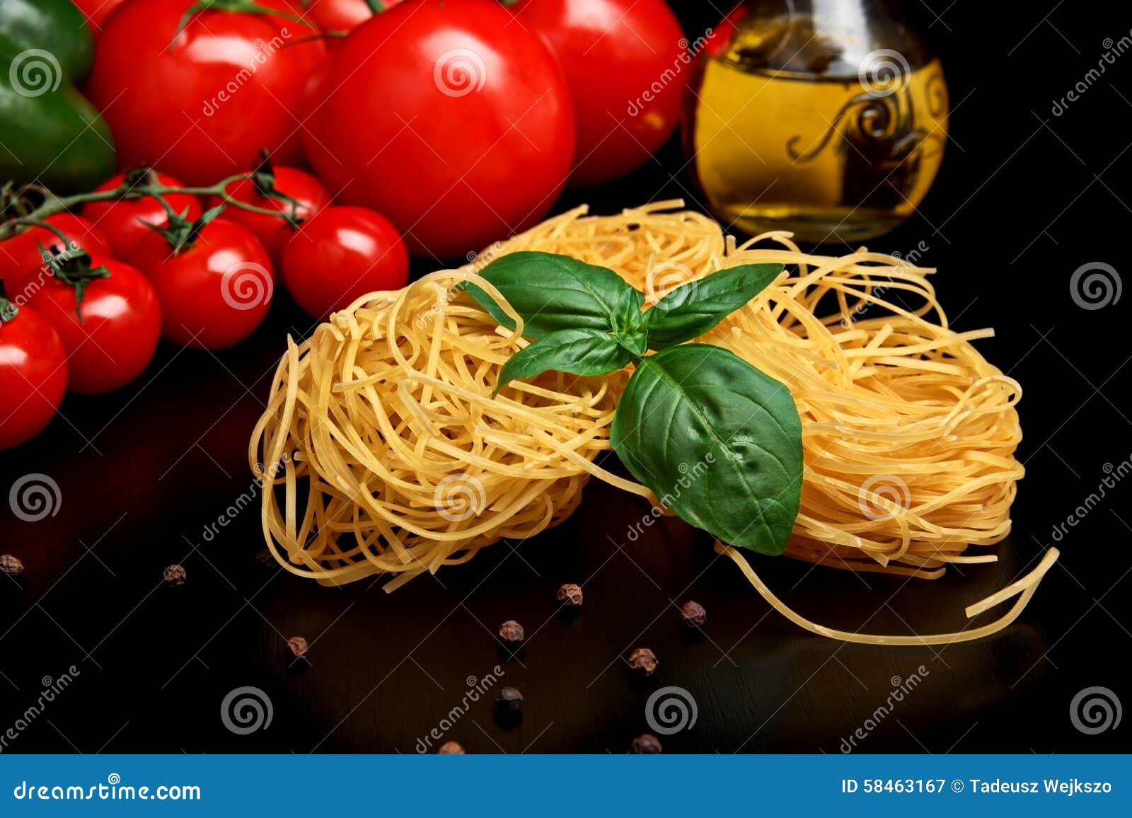Round Balls Of Pasta With Tomatoes,basil,olive Oil On Black Stock Image