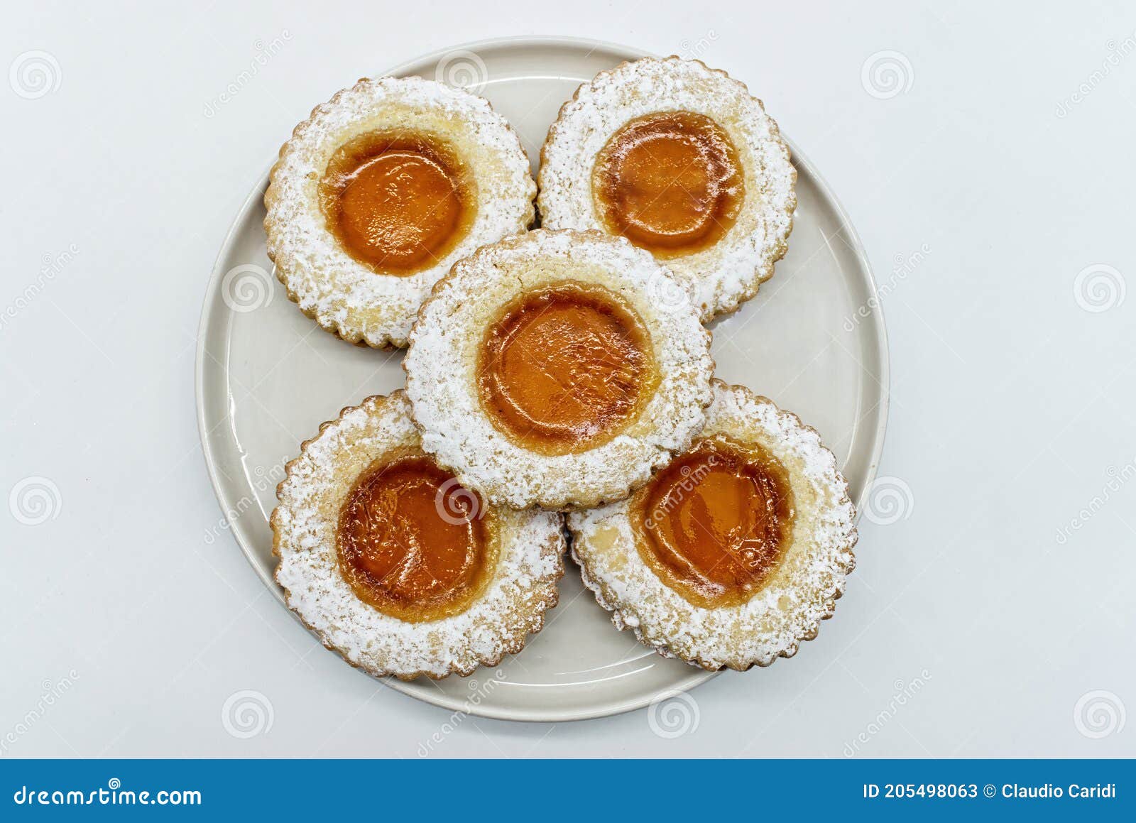 round cookies with fruit jam and icing sugar, italian occhi di bue,  on white
