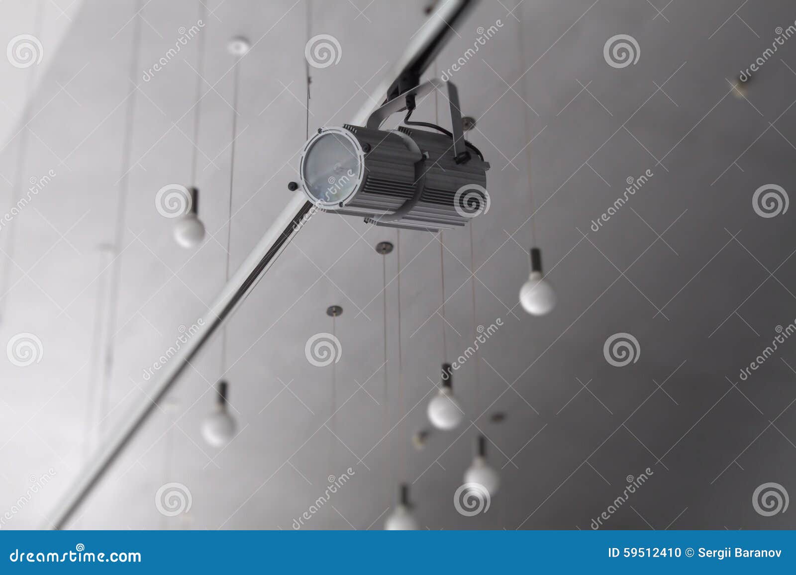 Round Lamps On Wires And Track Spotlights On Rail System At