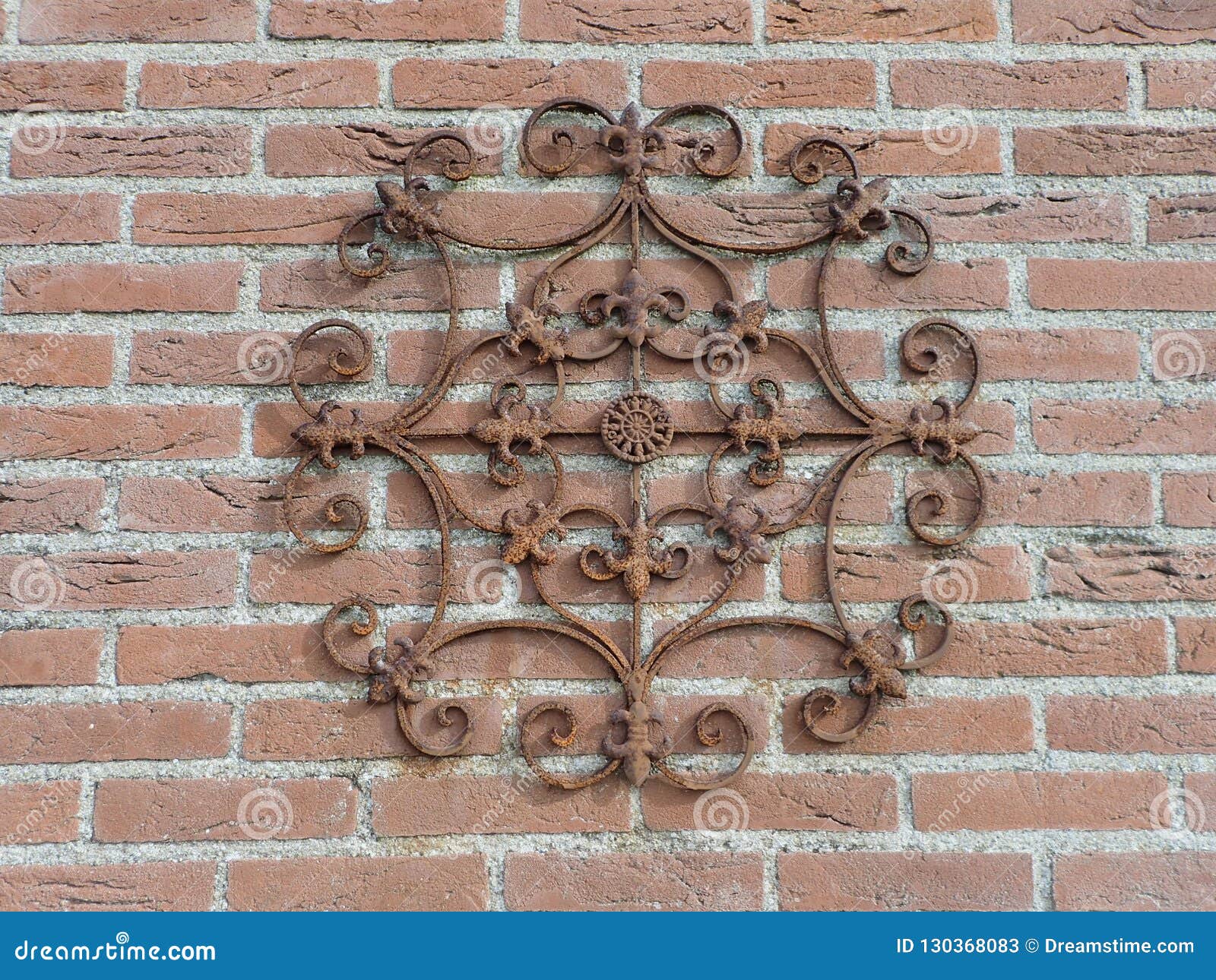 Round Metal Ornament on a Brick Wall Stock Image - Image of point ...