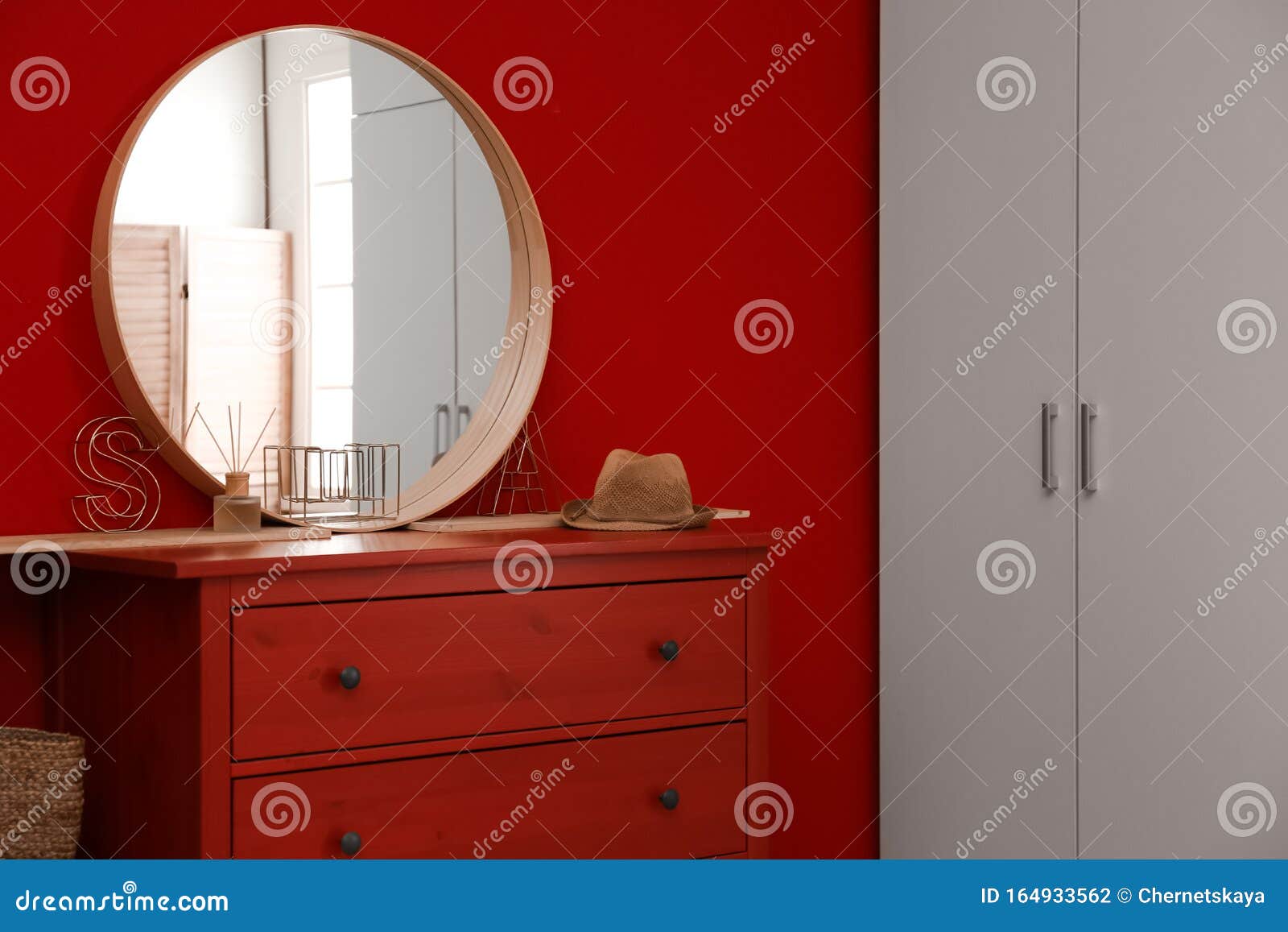 Round Mirror And Chest Of Drawers Near Wall In Room Modern