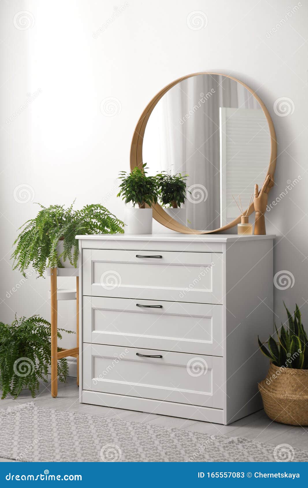 Round Mirror And Chest Of Drawers Near White Wall In Room Modern