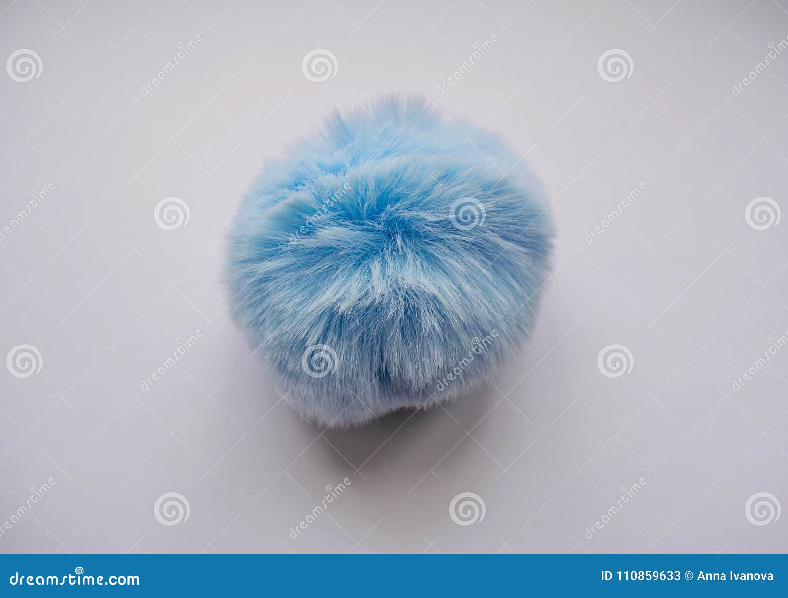 a round, spherical, fluffy, blue, soft ball is a toy.