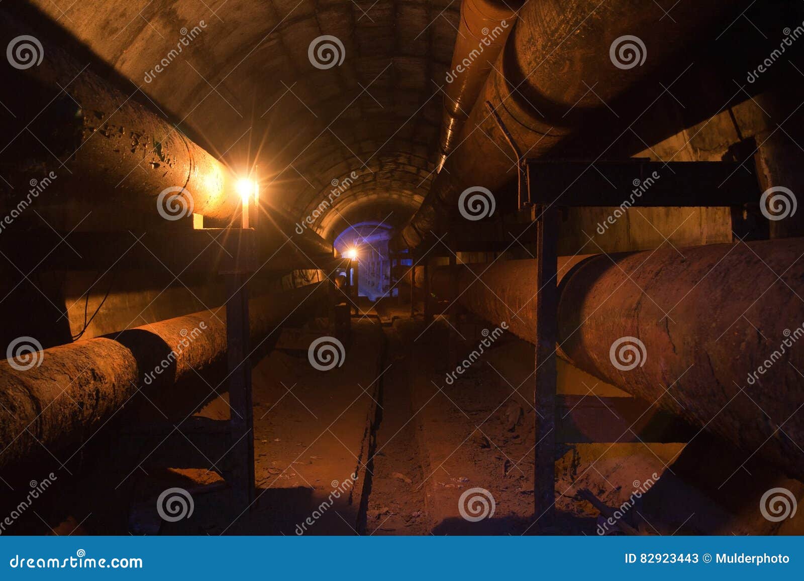 Round Underground Tunnel of Heating Duct with Rusty Tubes Stock Image