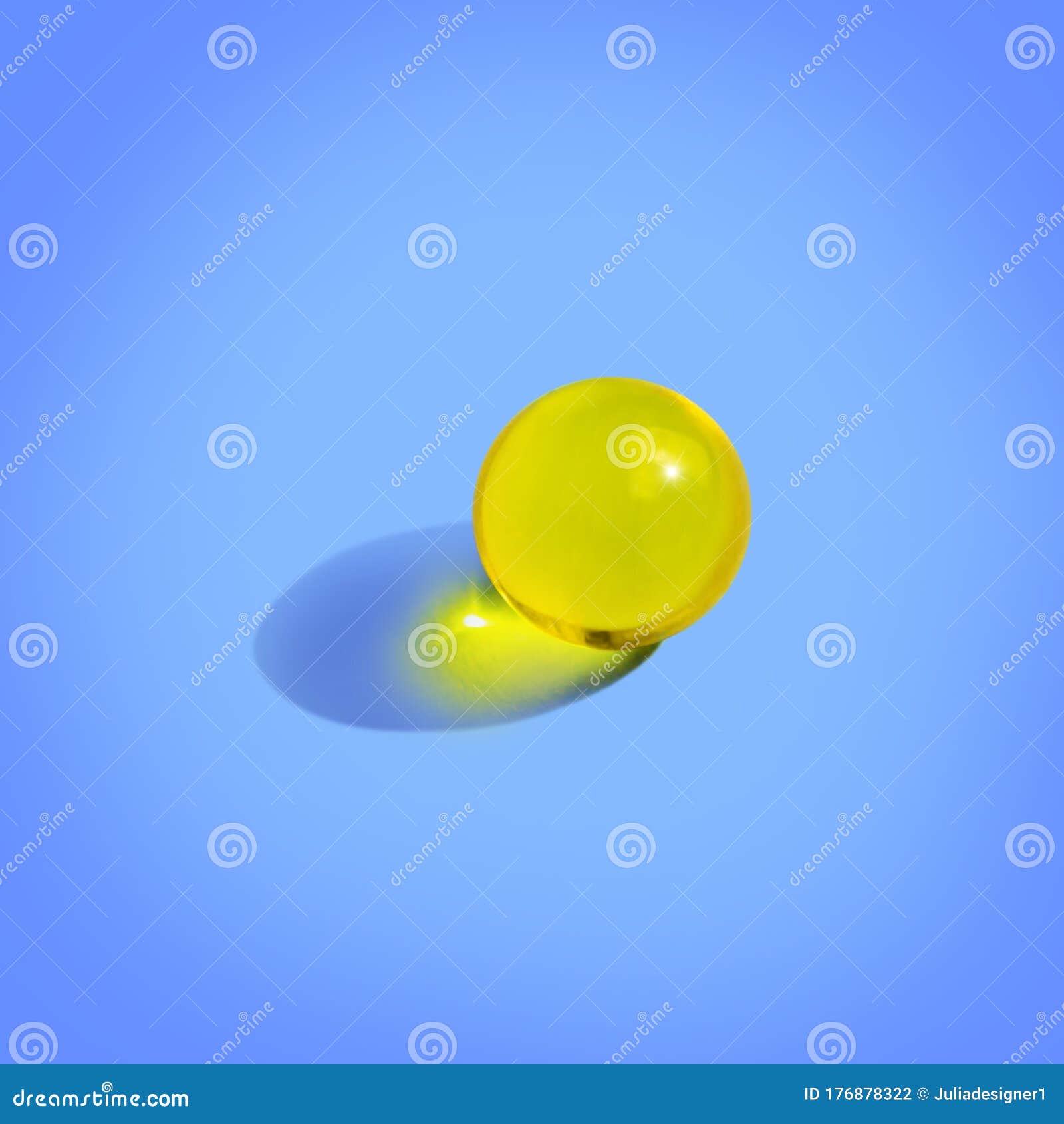 round yellow pill on blue background. close up pharmacy health care concept. organic liquid nutrition, oil