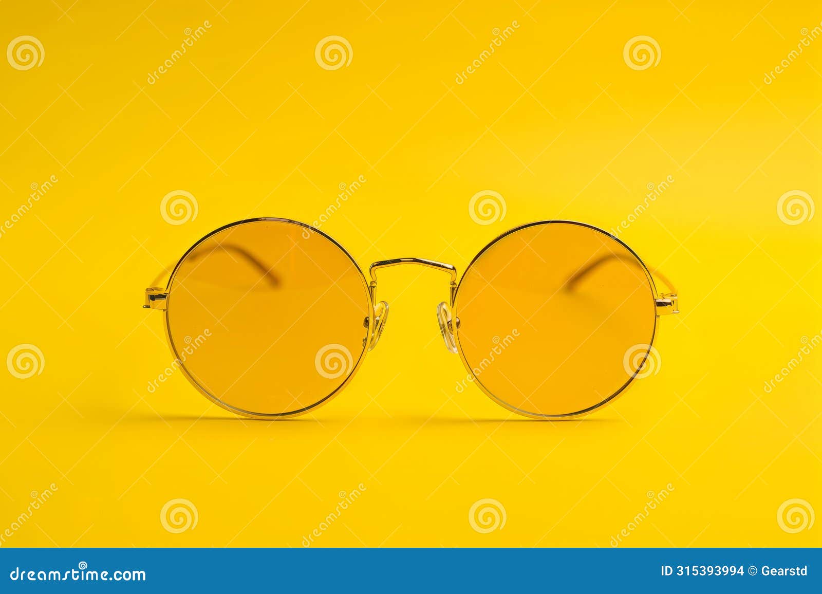 round yellow tinted sunglasses on yellow