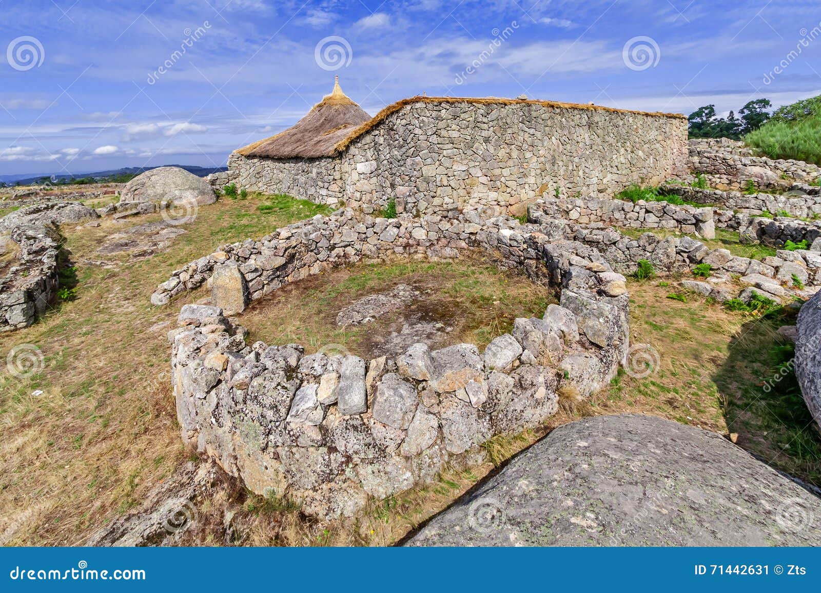 roundhouse ruins and the reconstructed family nucleus building in citania de sanfins