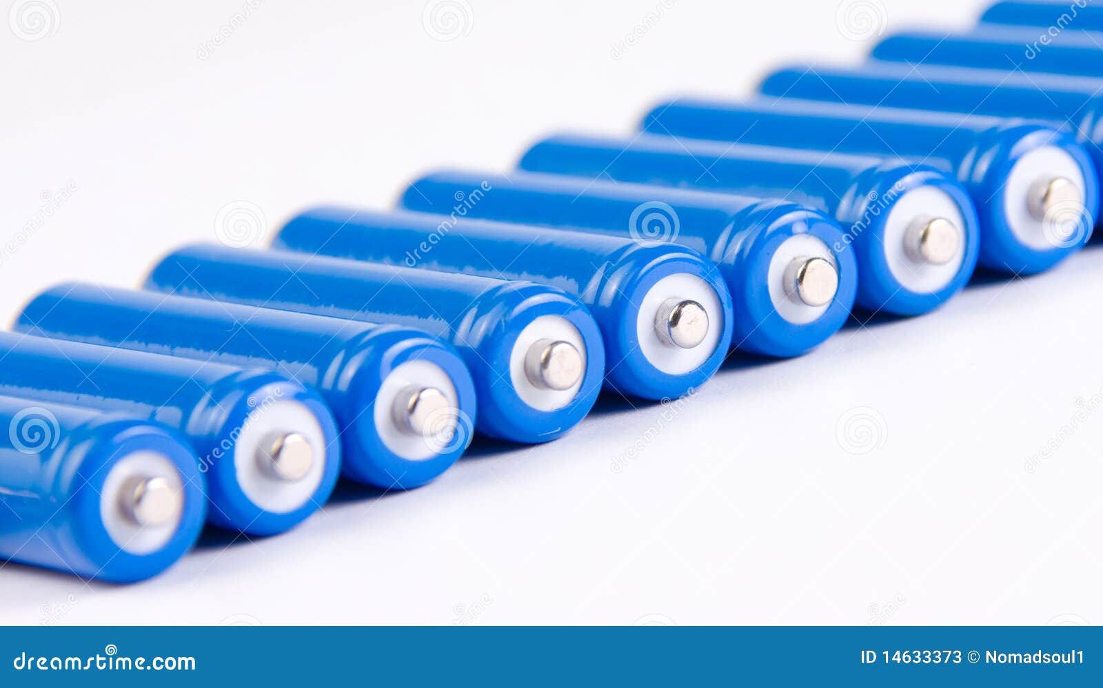 Row of blue batteries stock image. Image of batteries 14633373