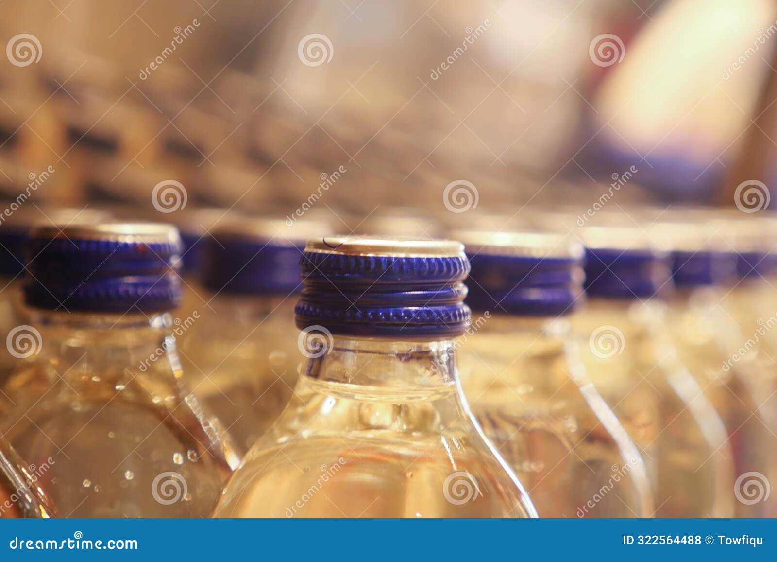 a row of bluecapped bottles is neatly arranged in an industrial factory for manufacturing purposes
