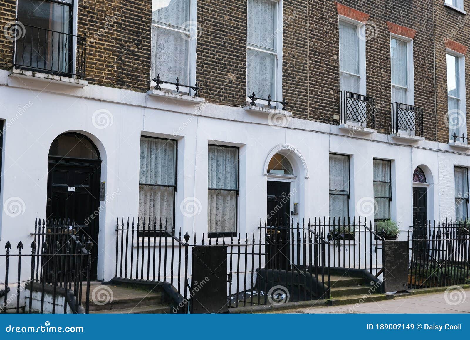 A Row of Brick Buildings with Black Doors on a Street in London Stock Image  - Image of architecture, english: 189002149