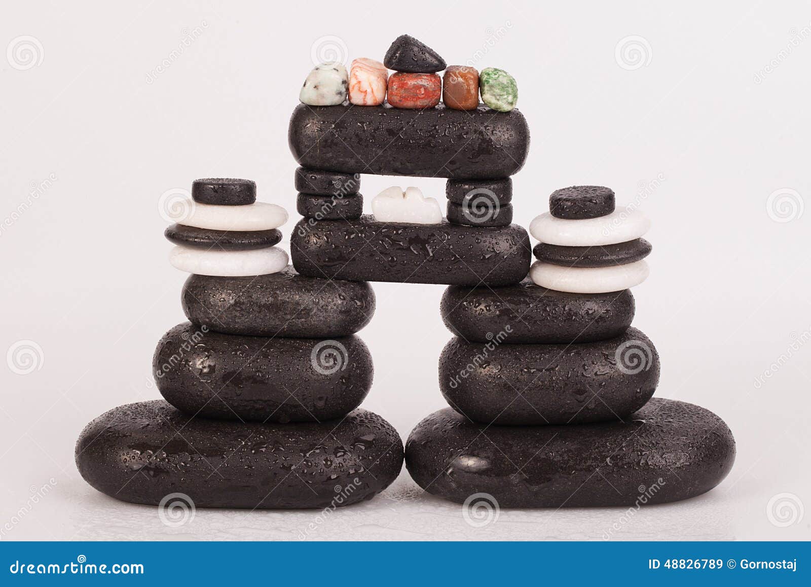 Row Of Chakra Crystals On Hot Massage Black Stones Stock