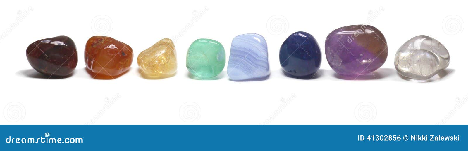 row of chakra crystals on white