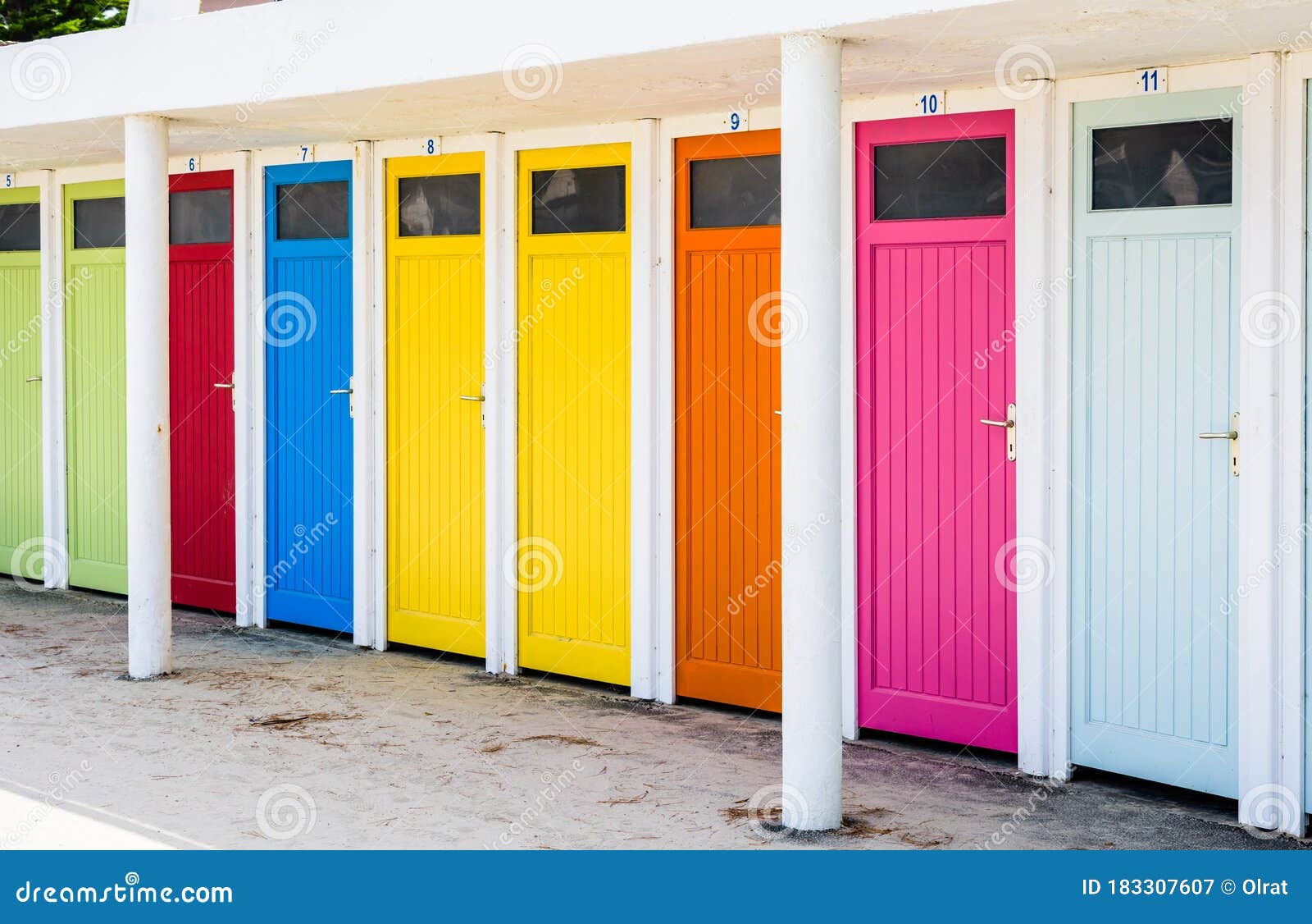 row of changing cubicles with colorful doors at the beach