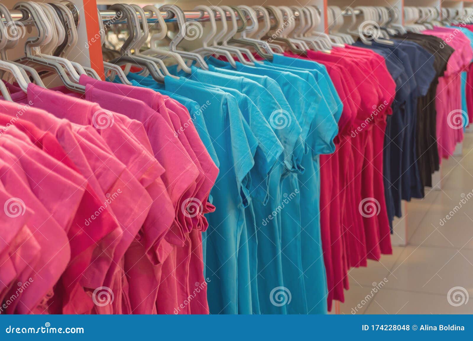 Row of Colorful T Shirts on Hangers. Fashion Retail Shop Display Stock ...