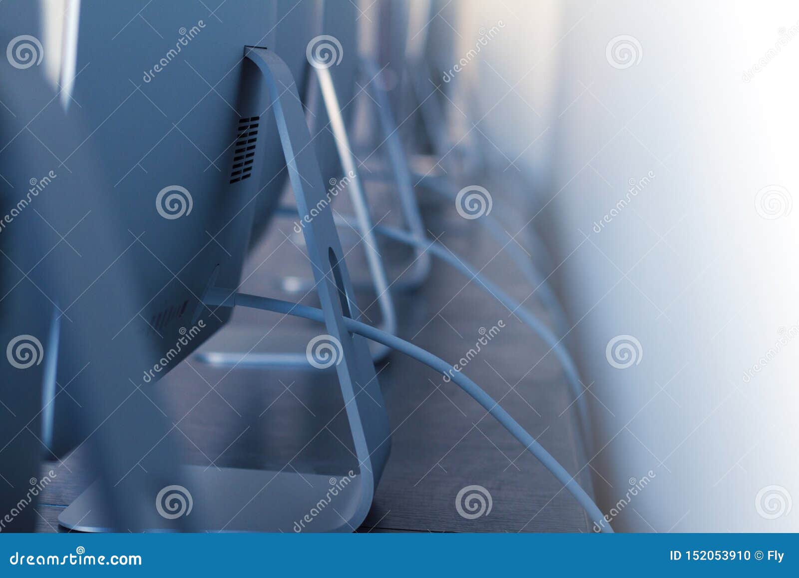Row Of Desktop Computers With Cables On Desk Stock Photo Image