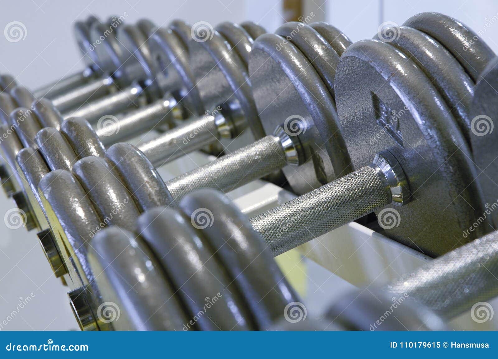 row of dumbbells for weight lifting in the gym