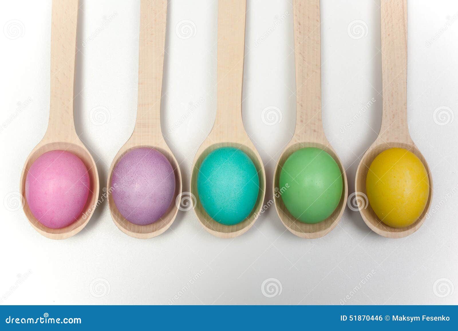 Row of Easter Eggs on Wooden Spoons Isolated White Stock Photo Image