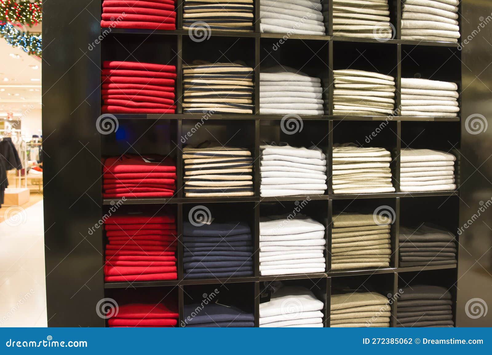 A Row of Folded Jackets on a Shelf in a Store Stock Photo - Image of ...