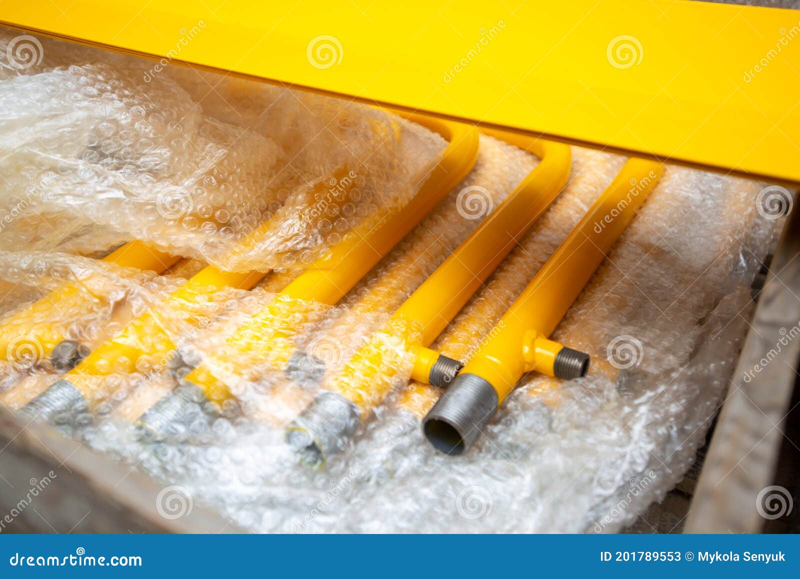 Row of Gas Pipes. Yellow Gas Pipes in Plastic Packing Stock Image