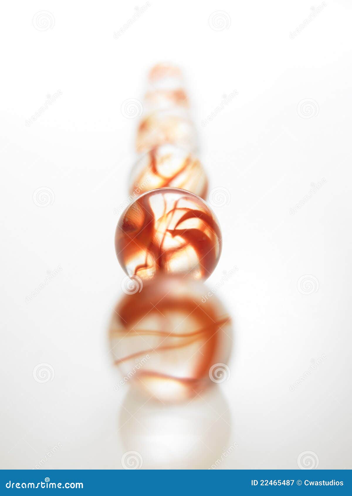 A row of glass Red marbles stock image. Image of reflective 22465487