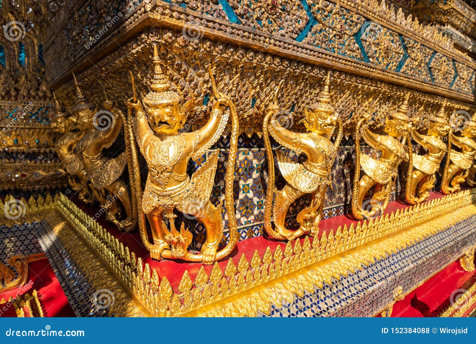 row of golden garuda scuplture wat phra kaew or the temple of the emerald buddha