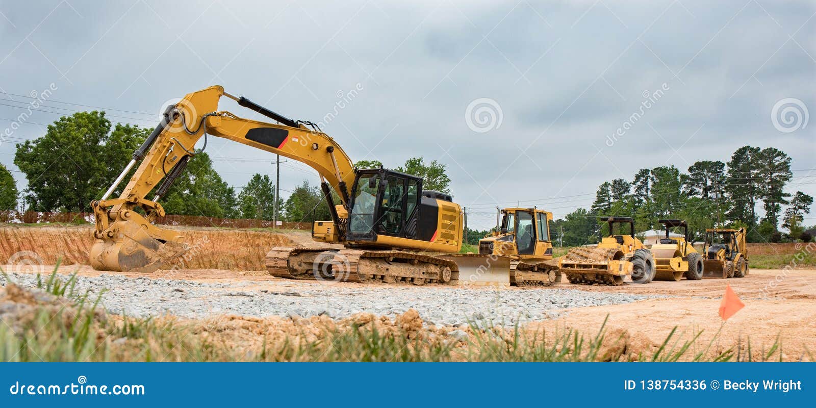 Heavy Construction Machinery in a Row at a Job Site. Stock Photo