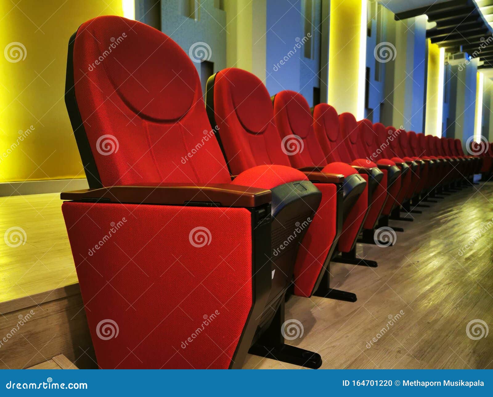 row of large red chair for watching movies in cinemas or theaters