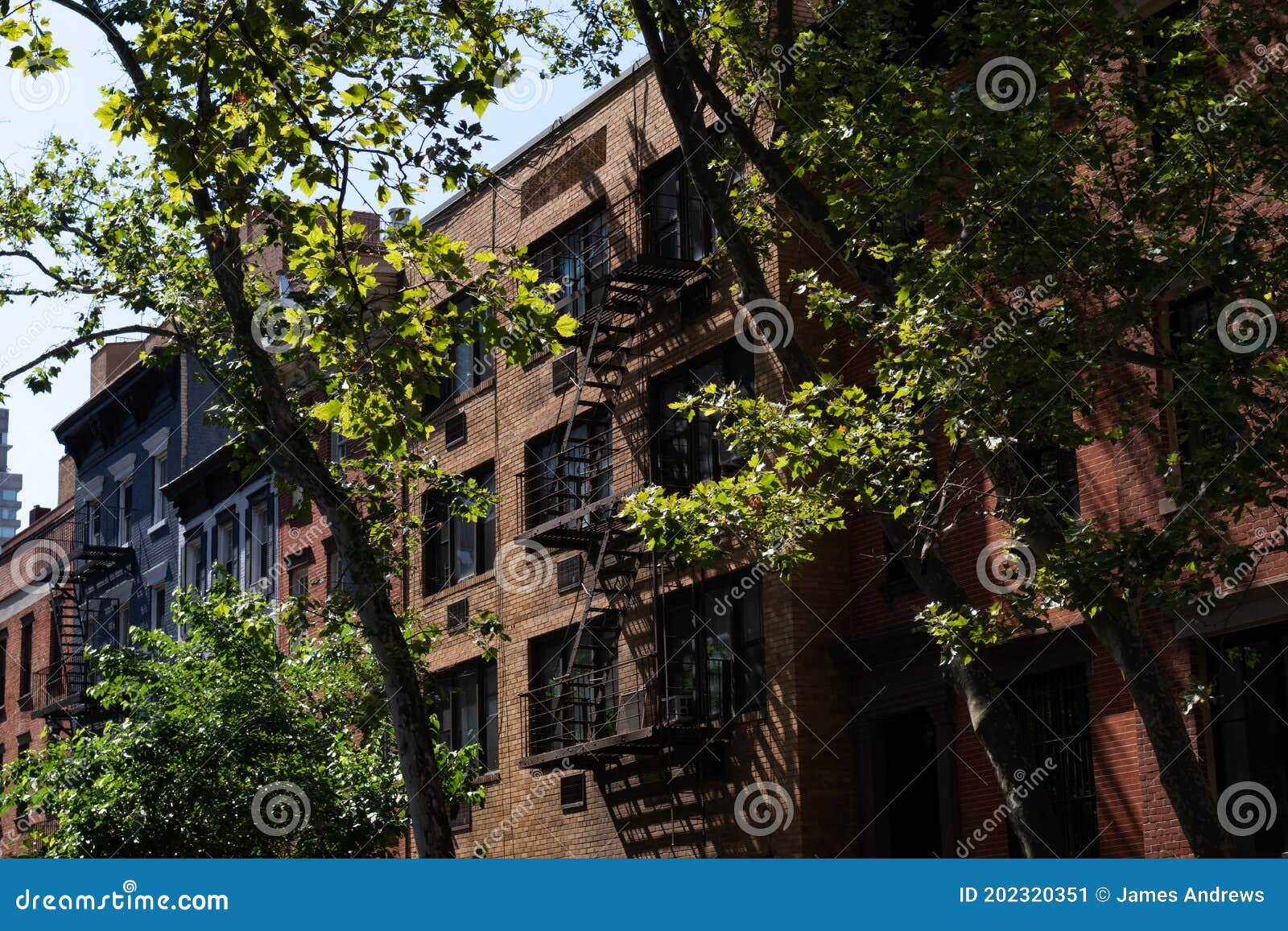 row of old brick residential buildings in kips bay of new york city