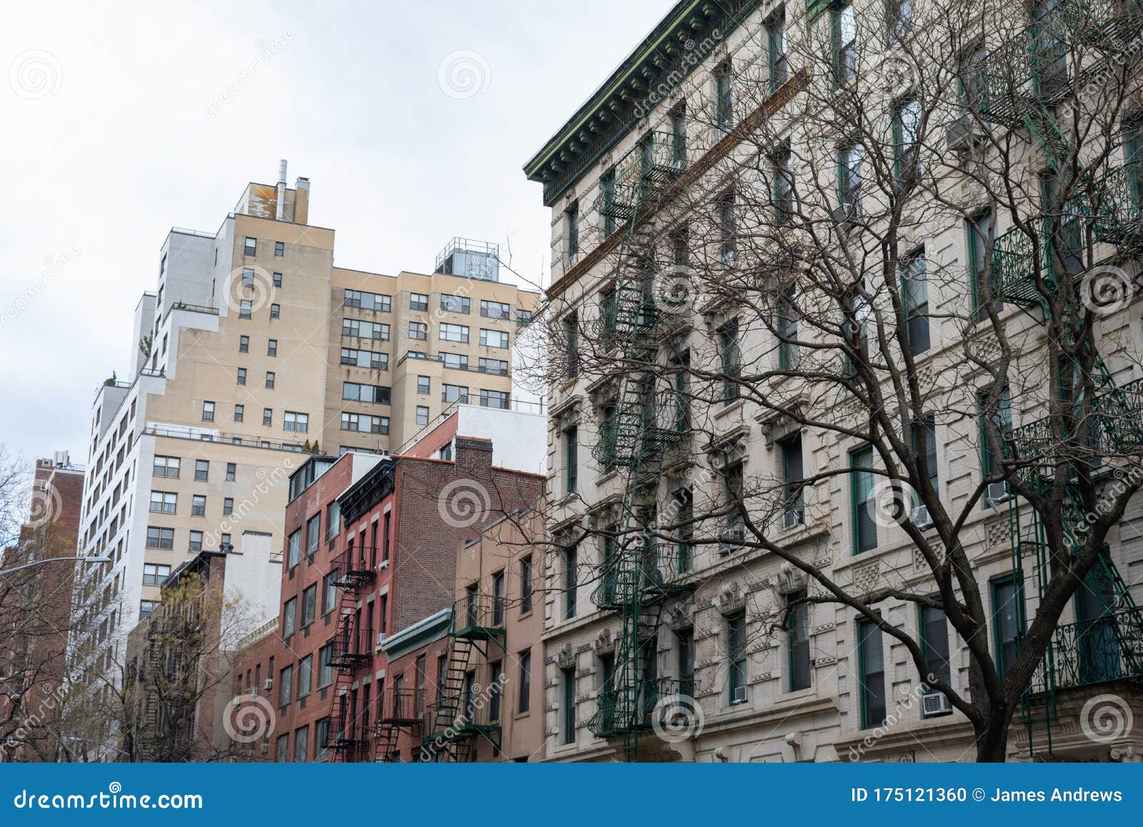 row of old buildings with fire escapes in kips bay new york city