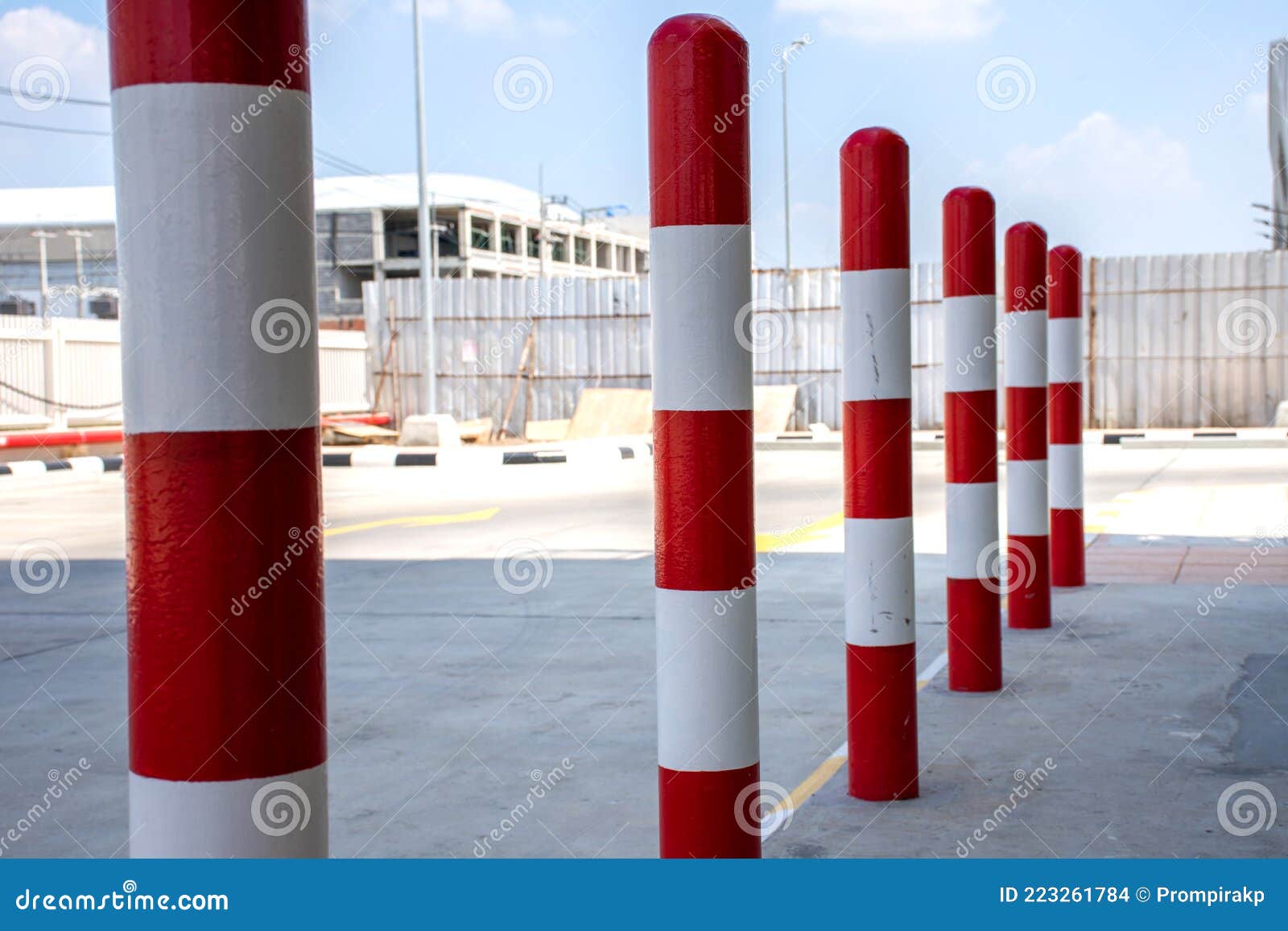 Row of Red and White Traffic Barrier Pole on Car Parking Lot Stock
