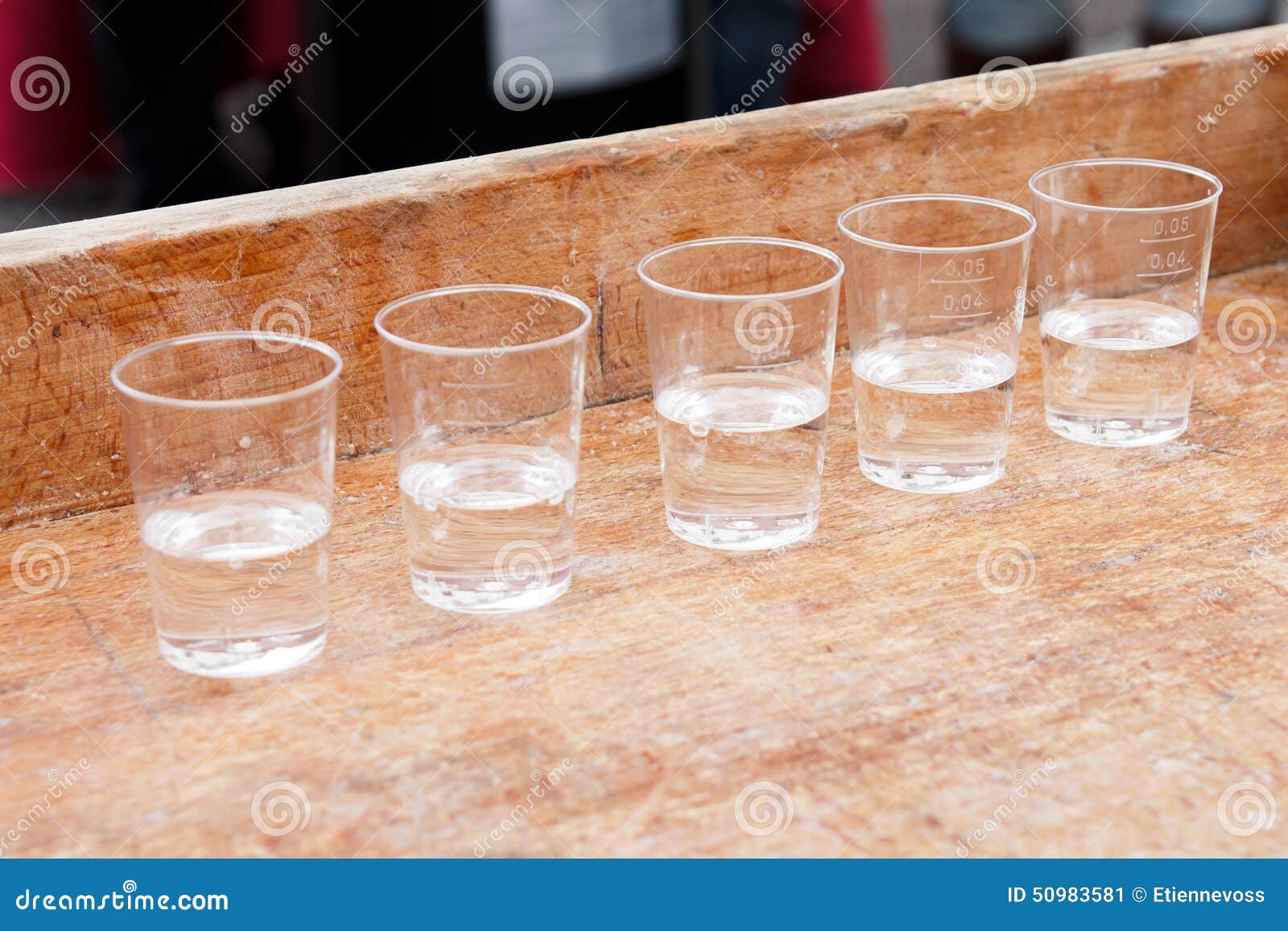 Row Of Shot Glasses With Vodka On Wooden Board Stock Image Image of